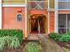 Inviting condo building entrance with colorful facade, staircase, and well-maintained landscaping at 4207 S Dale Mabry Hwy # 12204, Tampa, FL 33611