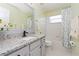 Bathroom with granite countertop, gray vanity, and a bathtub at 4224 Fleewell Ct, Valrico, FL 33596