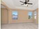 Spacious bedroom showcasing neutral walls, plush carpeting, and abundant natural light from multiple windows at 4224 Fleewell Ct, Valrico, FL 33596