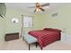 Bedroom with a red and black plaid comforter and ceiling fan at 4224 Fleewell Ct, Valrico, FL 33596