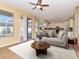 Gathering room with tile floors and view into kitchen at 4224 Fleewell Ct, Valrico, FL 33596