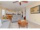 Open living room with gray couches and a view of the kitchen at 4224 Fleewell Ct, Valrico, FL 33596