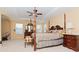 Main bedroom with a four-poster bed and ensuite bathroom access at 4224 Fleewell Ct, Valrico, FL 33596