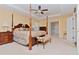 Main bedroom with a post bed, ensuite bathroom, and ample space at 4224 Fleewell Ct, Valrico, FL 33596