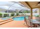 Screened pool and spa with patio furniture and lush landscaping at 4224 Fleewell Ct, Valrico, FL 33596