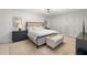 Spacious bedroom with tufted headboard, neutral decor, and ample closet space at 5700 Mariner St # 801E, Tampa, FL 33609