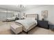 Bright bedroom features a tufted bed, mirrored closet doors and neutral tones at 5700 Mariner St # 801E, Tampa, FL 33609