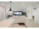 Modern kitchen with white cabinets, a peninsula, and stainless steel appliances at 5700 Mariner St # 801E, Tampa, FL 33609