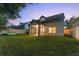 Home exterior view with screened porch and grassy backyard at 2944 Prairie Iris Dr, Land O Lakes, FL 34638