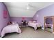 Cozy purple bedroom with two twin beds, a desk, and a ceiling fan at 2944 Prairie Iris Dr, Land O Lakes, FL 34638