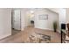 Hallway featuring wood floors, white walls, and access to various rooms at 2944 Prairie Iris Dr, Land O Lakes, FL 34638