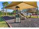 playground with slides, swings, and a shade structure at 2944 Prairie Iris Dr, Land O Lakes, FL 34638