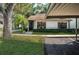 View of a house exterior with carport and landscaping at 3508 Magnolia Ridge Cir # 301, Palm Harbor, FL 34684