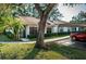 Single story home with carport parking and lush green landscaping at 3508 Magnolia Ridge Cir # 301, Palm Harbor, FL 34684