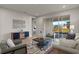 Living room with grey sofas and sliding glass doors to patio at 12224 Meditation Trl, Venice, FL 34293