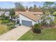 Single story home with brown roof, landscaping, and driveway, aerial view at 13606 Pub Pl, Tampa, FL 33618