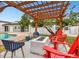 Relaxing backyard patio with fire pit, pergola, and comfortable seating at 13606 Pub Pl, Tampa, FL 33618