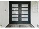 Modern dark double front doors with frosted glass panels at 13606 Pub Pl, Tampa, FL 33618