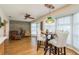 Sunlit dining area with wood floors and a wood accent wall at 2966 Macalpin N Dr, Palm Harbor, FL 34684