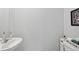 Clean and simple half bathroom with white sink and fixtures at 5310 Escena Ct, Tampa, FL 33611