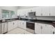 Modern kitchen with white cabinets and stainless steel appliances at 5310 Escena Ct, Tampa, FL 33611