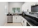 Modern kitchen with white cabinets and stainless steel appliances at 5310 Escena Ct, Tampa, FL 33611