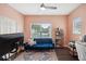 Home office with a blue sofa, and built-in shelving at 5310 Escena Ct, Tampa, FL 33611