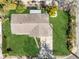 An aerial view of the roof and backyard with mature trees surrounding the property at 541 E Lime St, Tarpon Springs, FL 34689