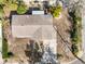 Aerial view of a home with a brown roof, complemented by lush greenery and a paved driveway at 541 E Lime St, Tarpon Springs, FL 34689