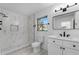 This stylish bathroom boasts modern fixtures, a marble tiled shower, and ample lighting at 541 E Lime St, Tarpon Springs, FL 34689
