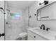 Bathroom with updated fixtures, marble tiled shower, and a modern vanity with black hardware at 541 E Lime St, Tarpon Springs, FL 34689