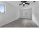 This bedroom features light gray wood-look flooring, a ceiling fan, and two windows at 541 E Lime St, Tarpon Springs, FL 34689