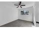 An empty bedroom with a ceiling fan and a window with a view of the neighborhood at 541 E Lime St, Tarpon Springs, FL 34689