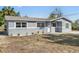 Charming home with a freshly painted exterior, landscaped yard, and a new roof at 541 E Lime St, Tarpon Springs, FL 34689