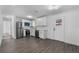 Bright kitchen featuring stainless steel appliances, modern gray flooring, and white cabinets at 541 E Lime St, Tarpon Springs, FL 34689