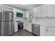 Bright kitchen featuring stainless steel appliances, white quartz countertops, and gray flooring at 541 E Lime St, Tarpon Springs, FL 34689