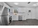 Bright kitchen features stainless steel appliances, white cabinets, and modern countertops at 541 E Lime St, Tarpon Springs, FL 34689