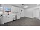 Bright kitchen featuring stainless steel appliances, white cabinets, and modern gray flooring at 541 E Lime St, Tarpon Springs, FL 34689