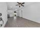 Bright living room featuring modern gray flooring, a ceiling fan, and white walls at 541 E Lime St, Tarpon Springs, FL 34689
