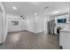 Open-concept area with modern gray flooring, stainless steel appliances, and white walls at 541 E Lime St, Tarpon Springs, FL 34689