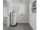 The utility room features gray wood-look flooring and a conventional water heater at 541 E Lime St, Tarpon Springs, FL 34689