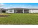 Expansive backyard with lush green lawn and covered patio perfect for outdoor entertaining at 2719 Winding Creek Trl, North Port, FL 34289