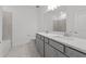 Bright bathroom with a double vanity, a toilet, and a bathtub shower combination at 2719 Winding Creek Trl, North Port, FL 34289