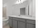 Well-lit bathroom boasts a gray vanity with a white countertop and a large mirror at 2719 Winding Creek Trl, North Port, FL 34289