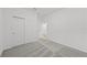 Bedroom with neutral carpet, double closets, and a hallway leading to other rooms at 2719 Winding Creek Trl, North Port, FL 34289