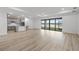 Spacious living room features a large window overlooking a serene lake, filling the space with natural light at 2719 Winding Creek Trl, North Port, FL 34289