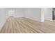 Open-concept living area with stylish flooring and abundant natural light creates an inviting and modern ambiance at 2719 Winding Creek Trl, North Port, FL 34289