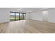 Light-filled living space showcasing a large sliding glass door with a view of the outdoors and a modern tray ceiling at 2719 Winding Creek Trl, North Port, FL 34289