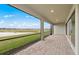 Relaxing patio provides views of the lake and easy access to interior with sliding glass doors at 2719 Winding Creek Trl, North Port, FL 34289
