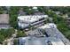 Aerial view of a commercial building surrounded by lush green trees, featuring ample parking and a modern architectural design at 800 S Dakota Ave # 116, Tampa, FL 33606